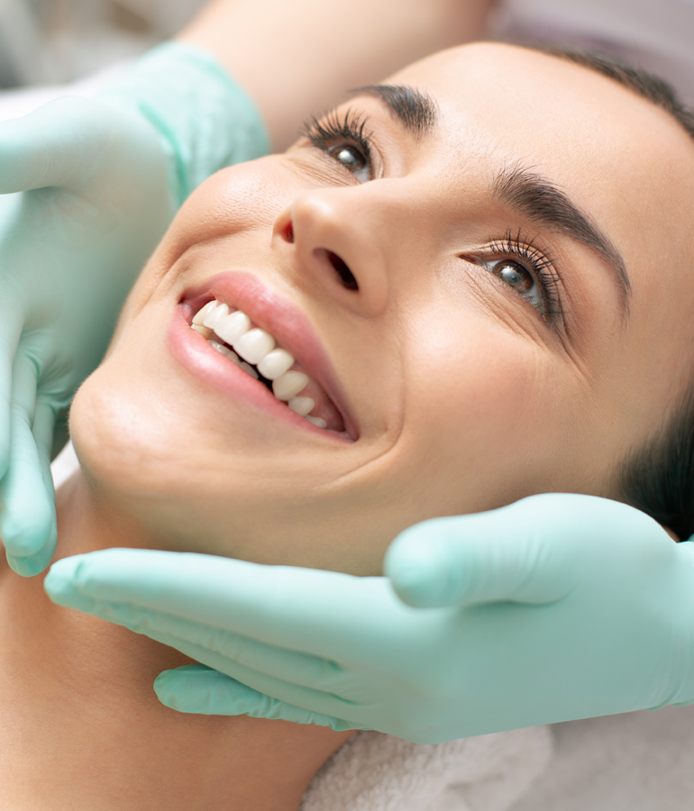 woman smiling during facial treatment | La Jolla Cosmetic Laser Clinic In San Diego