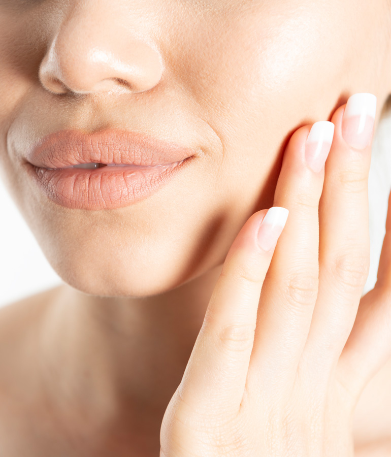 womans hand on fresh face | La Jolla Cosmetic Laser Clinic In San Diego