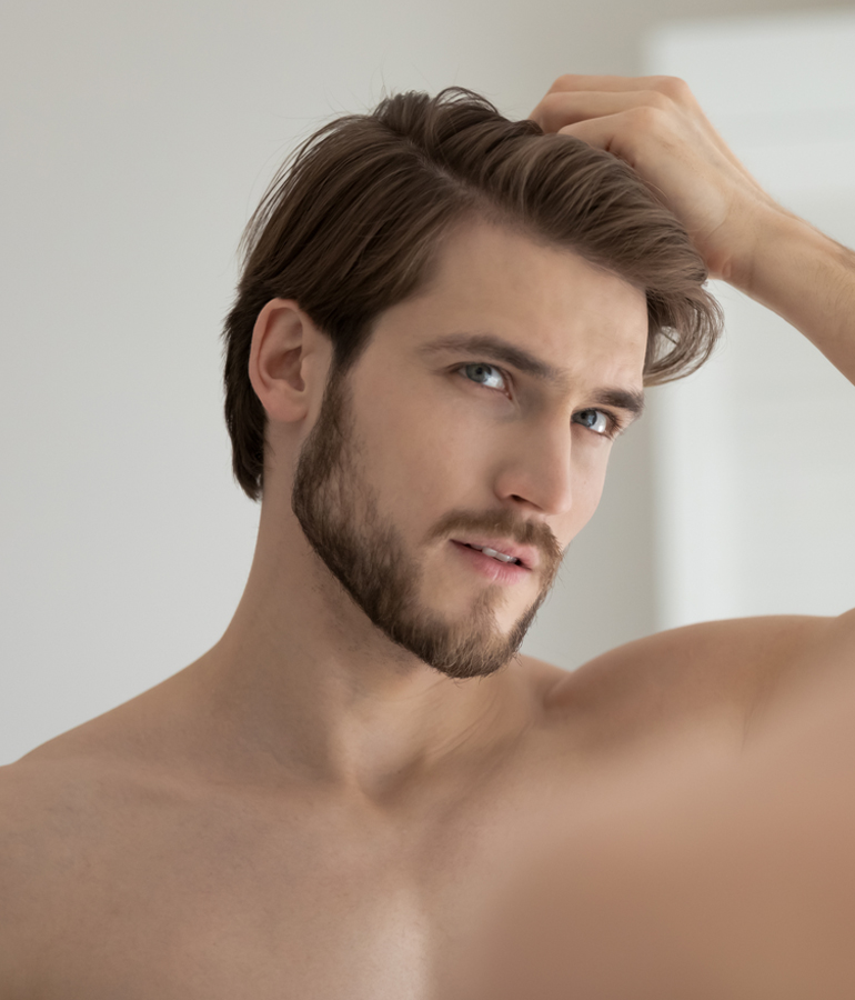 Man admiring his full hair with PRP Treatment | La Jolla Cosmetic Laser Clinic In San Diego