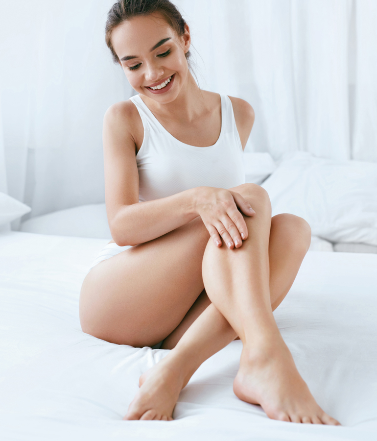 Womans hands running over legs | La Jolla Cosmetic Laser Clinic In San Diego